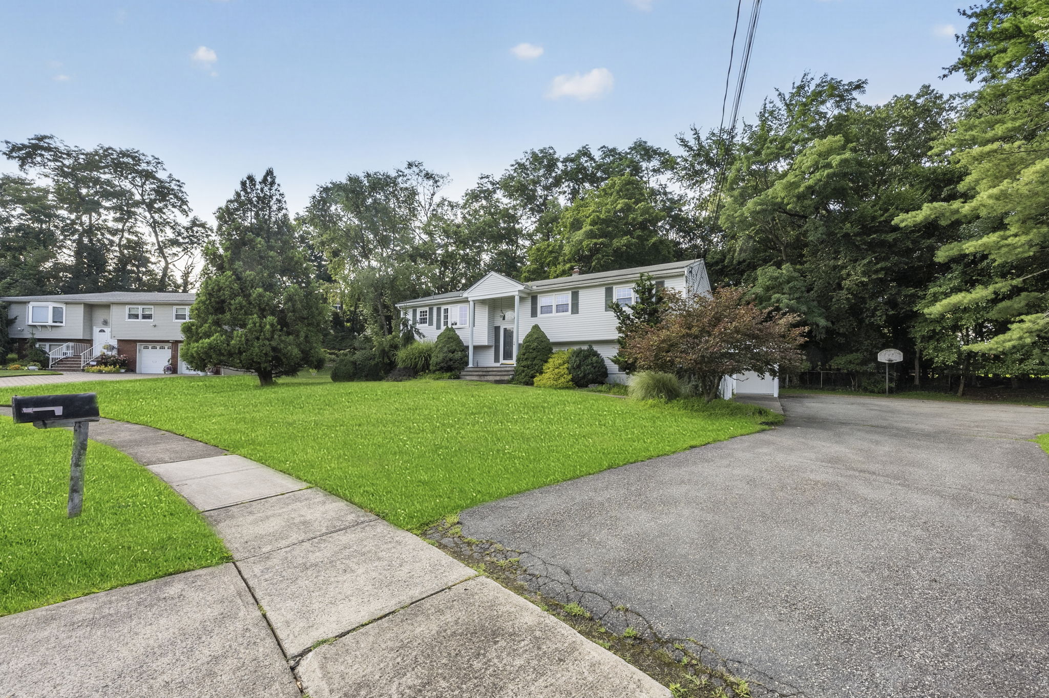 Set on a larger-than-typical property of nearly 3/4 acre, this 5-bedroom, 4-bath bi-level offers 2,796 sq ft of living space. Great curb appeal, a large driveway, and a side-entry garage create a memorable first impression as you arrive along the sidewalk-lined, tree-lined street.