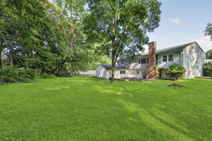 A large stone patio overlooks the expansive backyard, providing plenty of room to dine, relax, garden, or entertain throughout the seasons. With nearly 3/4 acre, this property offers the outdoor space so many buyers are searching for.