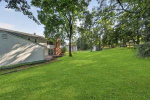 A large stone patio overlooks the expansive backyard, providing plenty of room to dine, relax, garden, or entertain throughout the seasons. With nearly 3/4 acre, this property offers the outdoor space so many buyers are searching for.