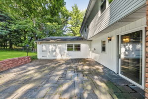 A large stone patio overlooks the expansive backyard, providing plenty of room to dine, relax, garden, or entertain throughout the seasons. With nearly 3/4 acre, this property offers the outdoor space so many buyers are searching for.