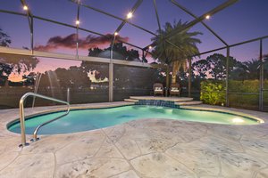 Twilight Swimming Pool with Waterfall and Fountain