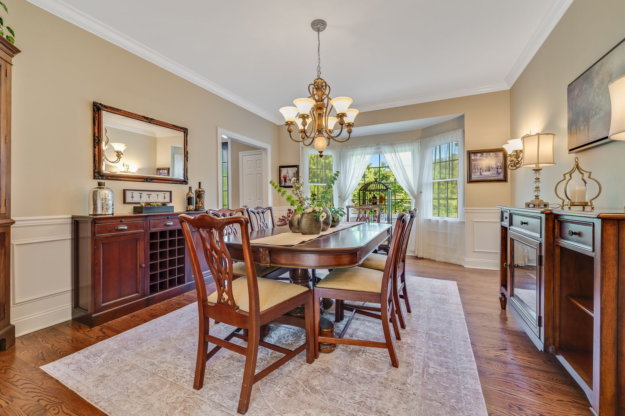 FORMAL DINING ROOM Crown and Chair Rail Moulding, Box Trim, Bronze and Frosted Glass Light Fixture, Sconces, Bay Window, Hardwood Flooring