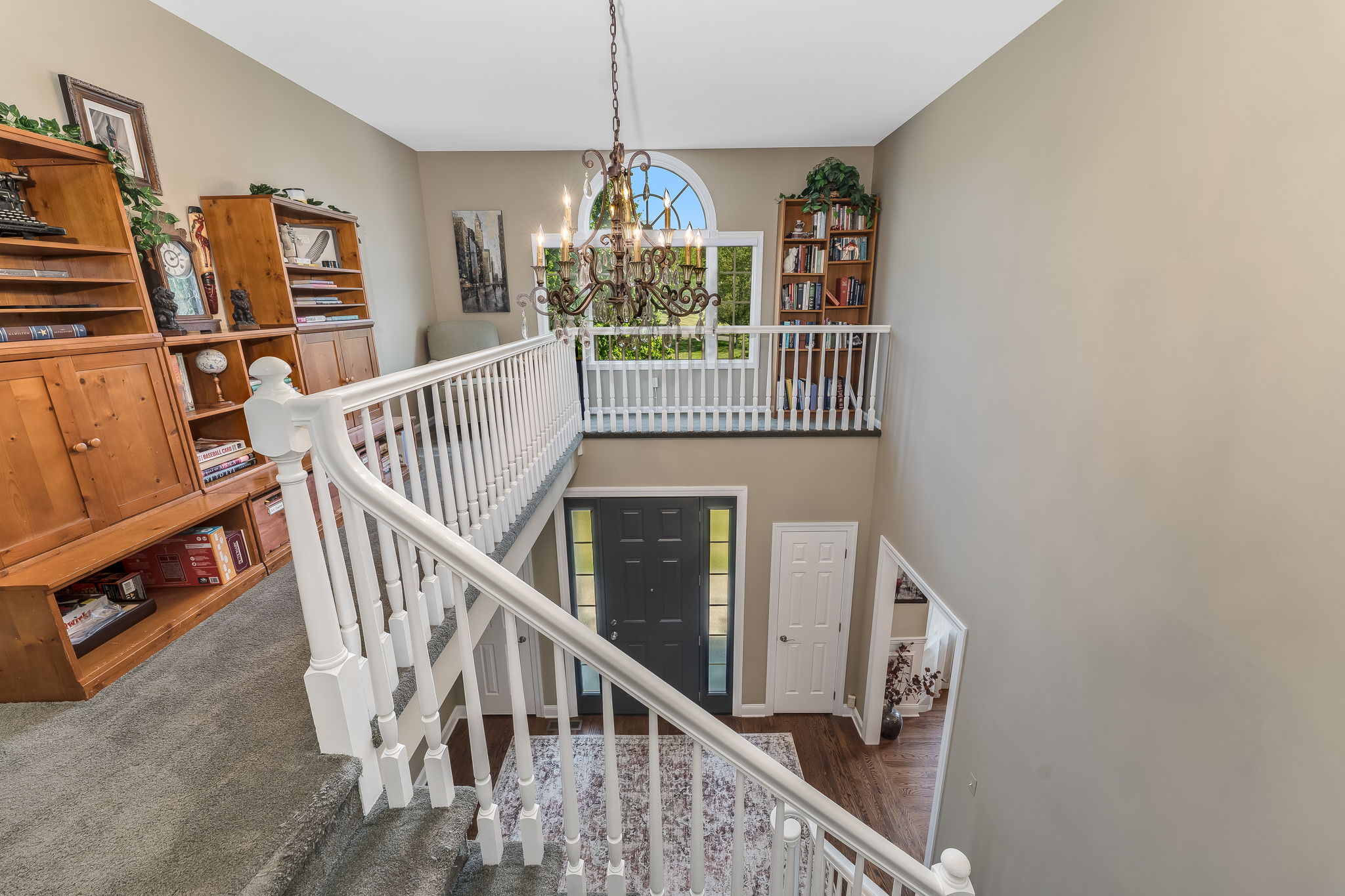 SECOND STORY LANDING From the second level, the open staircase and landing offers a view down into the foyer.
