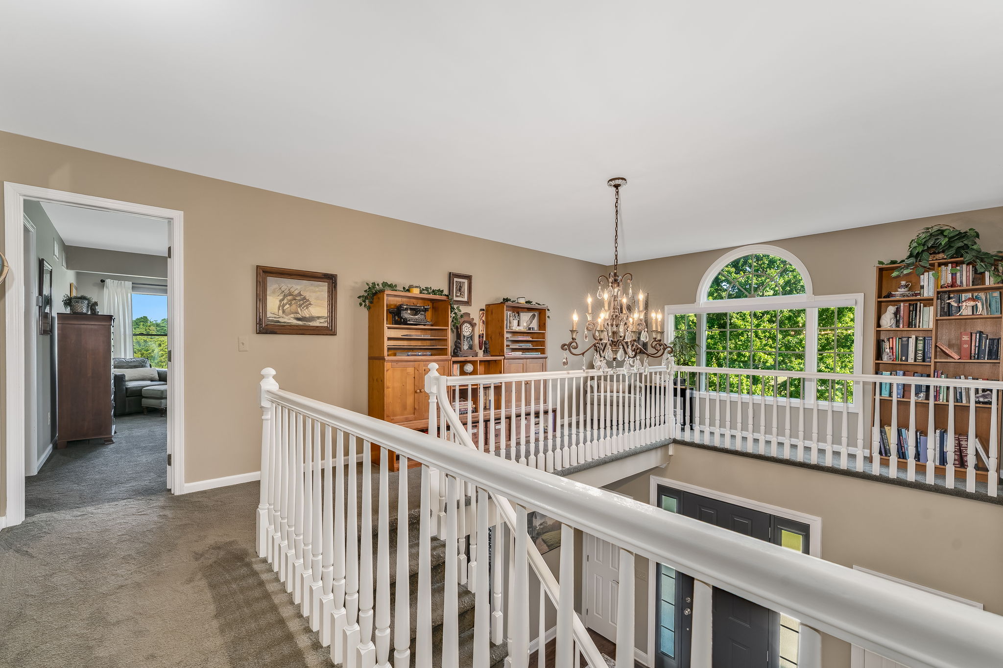 SECOND STORY LANDING From the second level, the open staircase and landing offers a view down into the foyer.