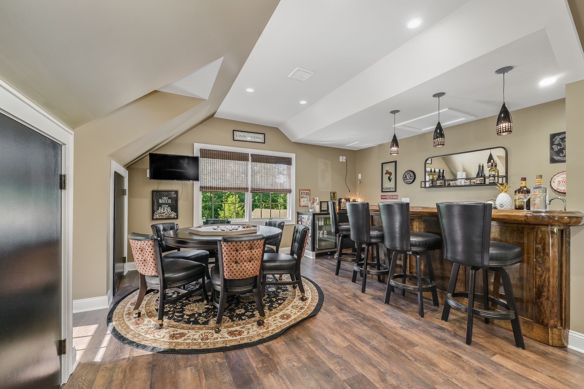 GAMEROOM The expansive game room is the ultimate entertainment destination, complete with a built-in bar, wet sink, and pool table-ideal for game nights, celebrations, or enjoying a casual evening at home.