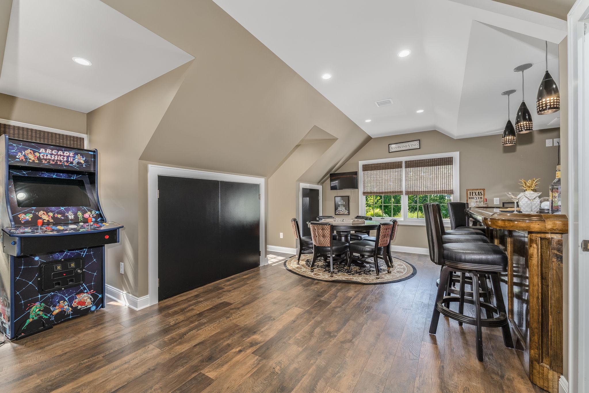 GAMEROOM The expansive game room is the ultimate entertainment destination, complete with a built-in bar, wet sink, and pool table-ideal for game nights, celebrations, or enjoying a casual evening at home.