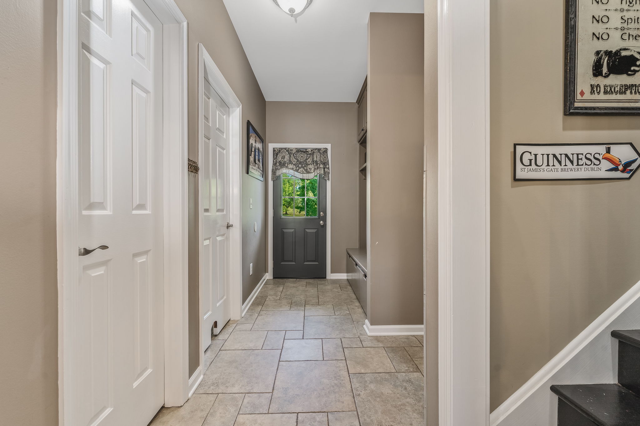 SECONDARY ENTRY/HALLWAY Secondary Entry Door, Custom Built-in Organizer, Ceramic Tile Floor