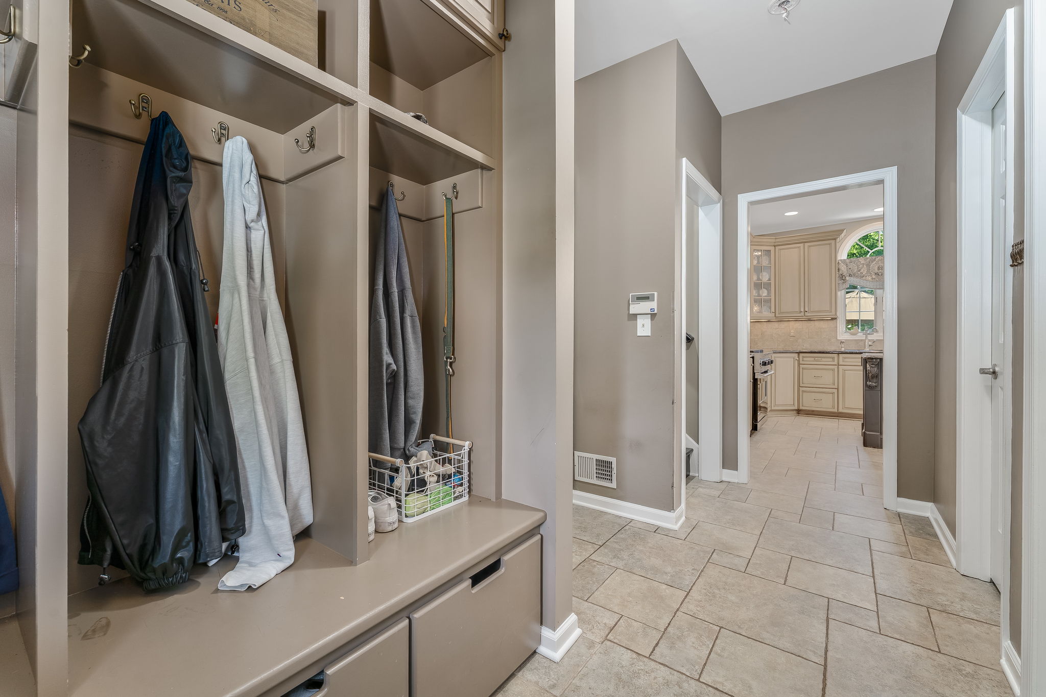 SECONDARY ENTRY/HALLWAY Secondary Entry Door, Custom Built-in Organizer, Ceramic Tile Floor