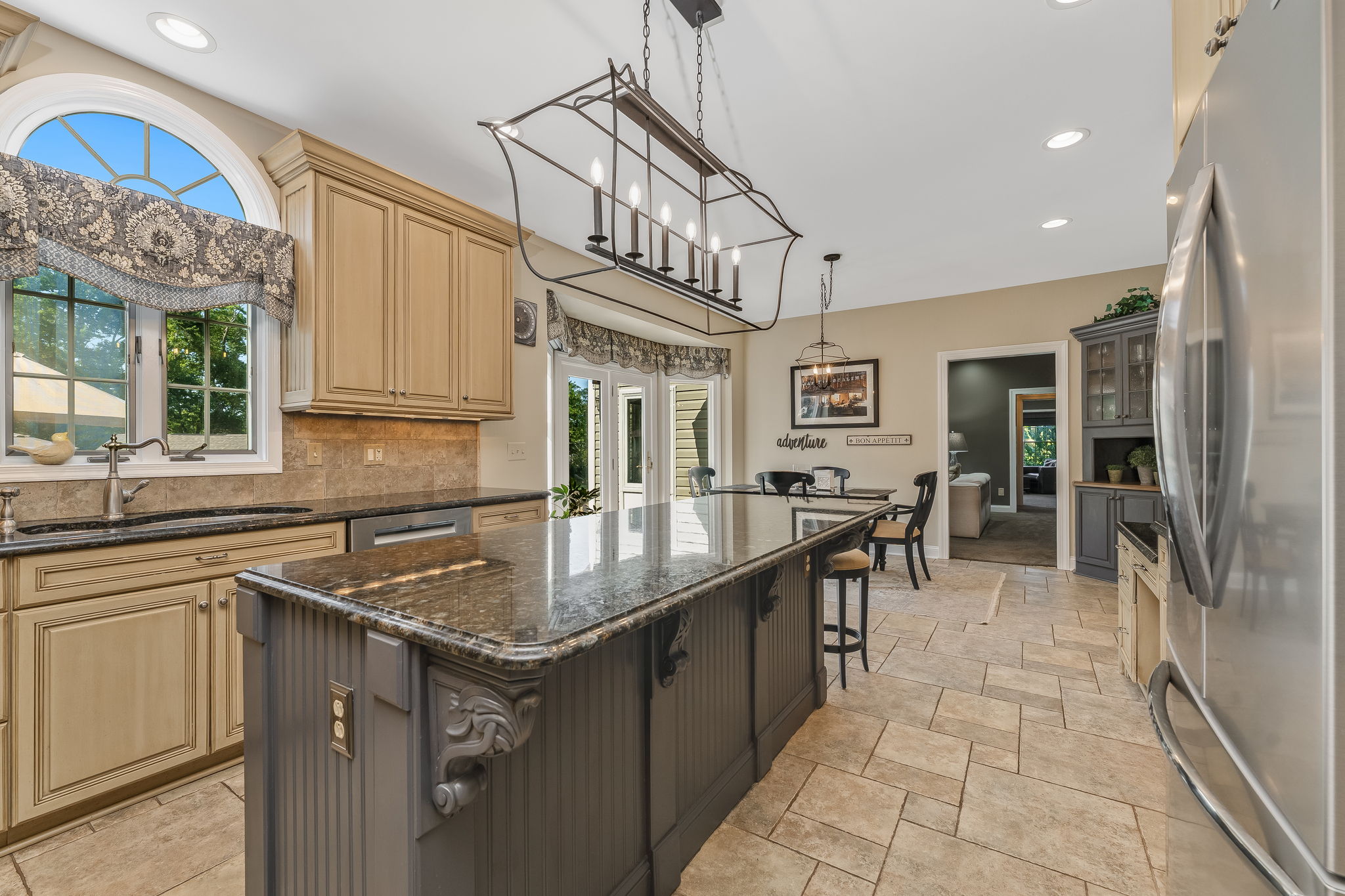 GOURMET KITCHEN Gourmet chef's kitchen features premium finishes, high-end appliances, and abundant prep space. Center Island with Breakfast Seating and Granite Countertop