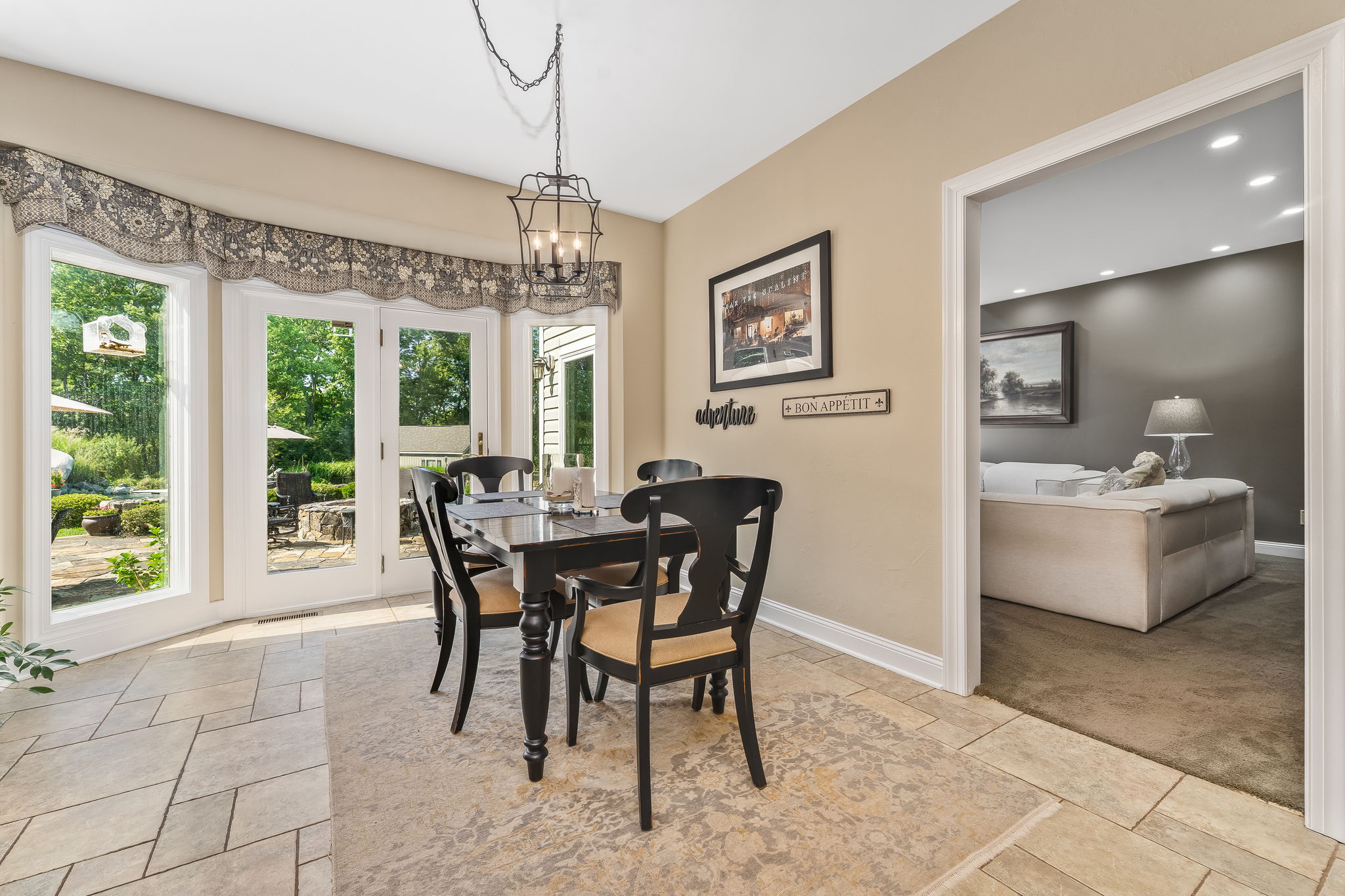 BREAKFAST AREA 4 Glass Panels/Patio Door Opens to Outdoor Kitchen and Stone Patio