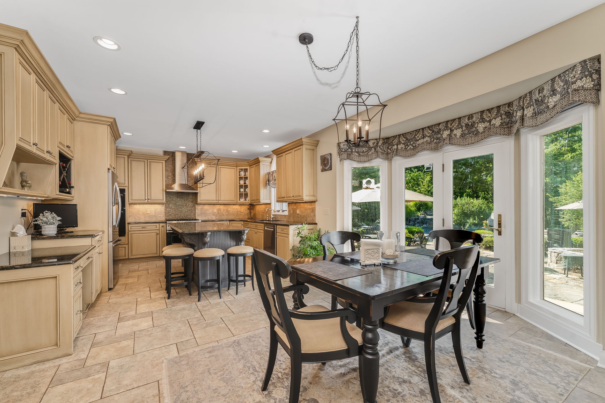 GOURMET KITCHEN Gourmet chef's kitchen features premium finishes, high-end appliances, and abundant prep space. Center Island with Breakfast Seating and Granite Countertop