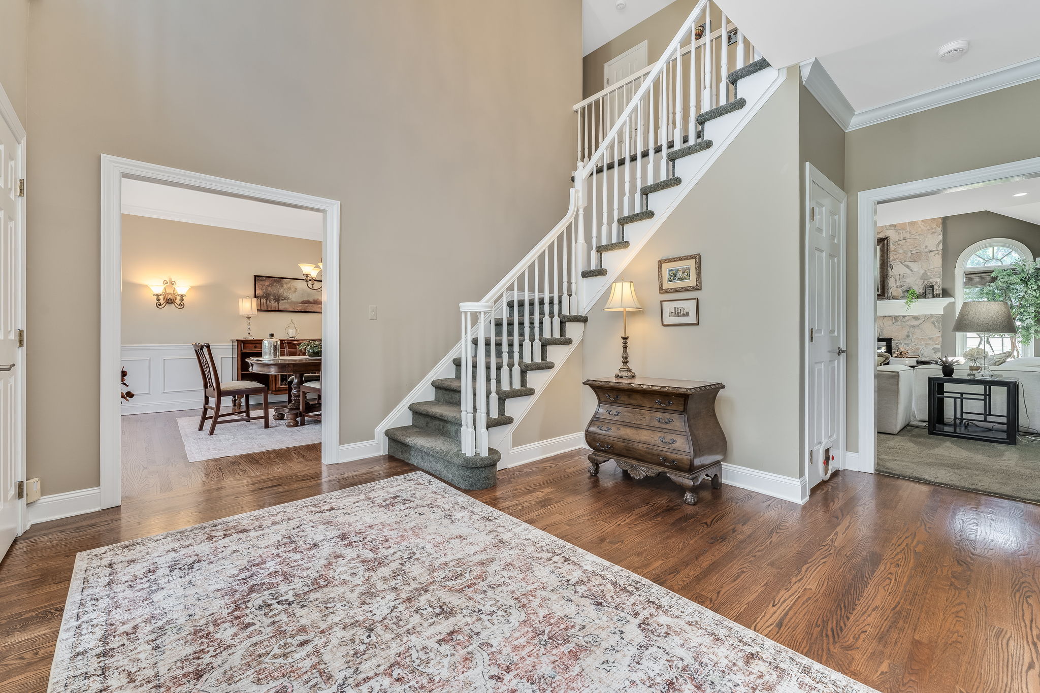 TWO STORY FOYER Andersen Entry Door with Sidelights, Crown Moulding, 2 Tier Candle Chandelier, Sentry Closets, Hardwood Flooring