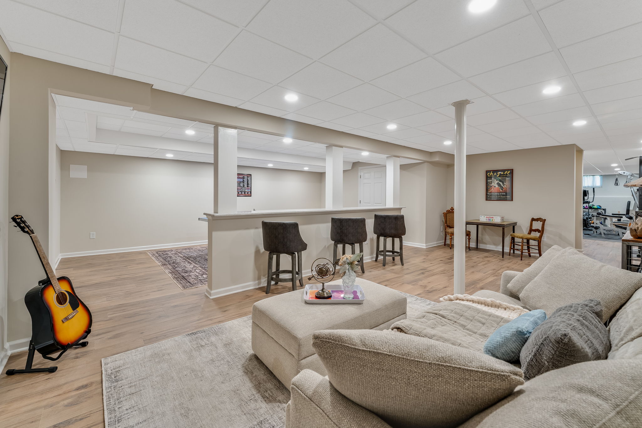 FINISHED LOWER LEVEL The finished walk-out lower level offers exceptional versatility with a spacious recreation room, dedicated fitness room, and generous storage areas to keep everything organized.