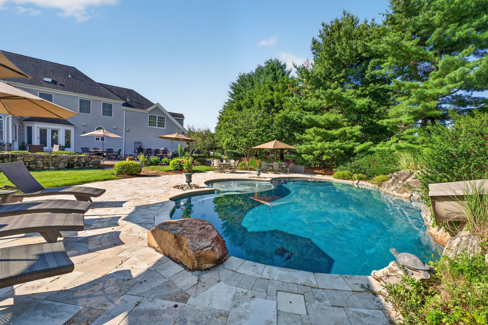 PATIO/POOL Completing the private backyard oasis is a heated saltwater pool with a custom pool slide, offering the ultimate resort-style experience right at home.