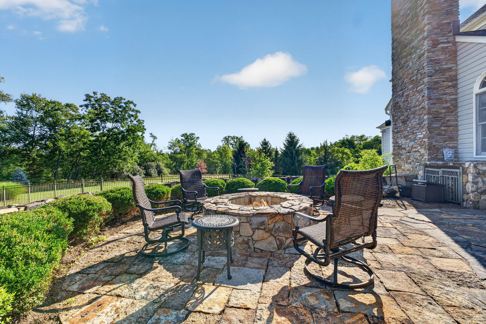 PATIO/STONE FIREPIT A sprawling stone patio with stone firepit creates the perfect setting for relaxing,
