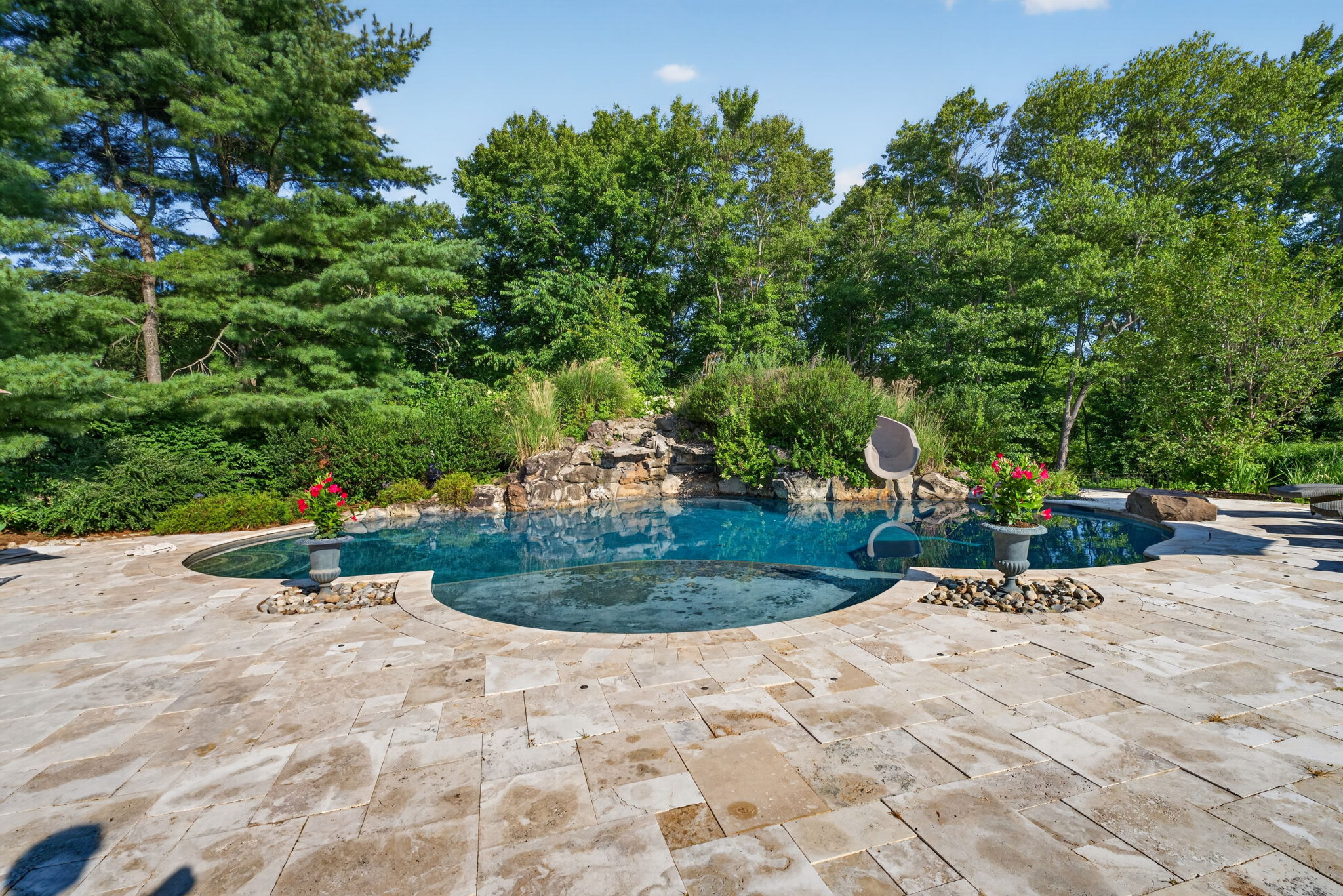SALTWATER POOL Custom Heated Saltwater Pool with Travertine Coping And Patio Surround/Natural Stone Waterfall/Custom Slide/Pennsylvania Moss Rock Diving Stone. Polaris Aqua Plus Robotic Pool Cleaner (included).