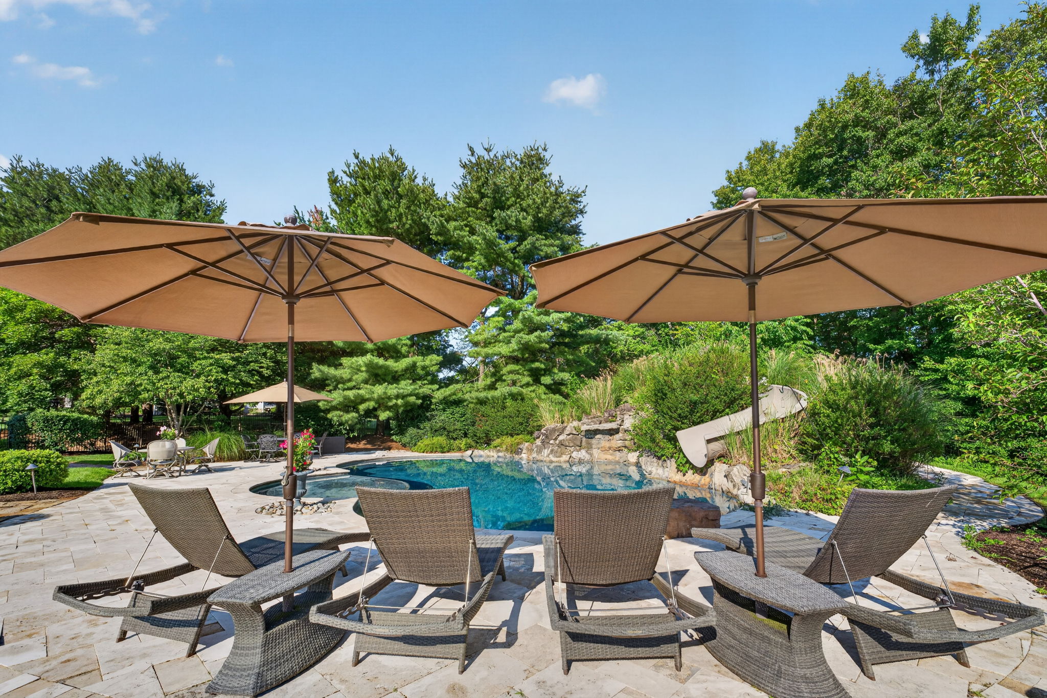 SALTWATER POOL Custom Heated Saltwater Pool with Travertine Coping And Patio Surround/Natural Stone Waterfall/Custom Slide/Pennsylvania Moss Rock Diving Stone. Polaris Aqua Plus Robotic Pool Cleaner (included).