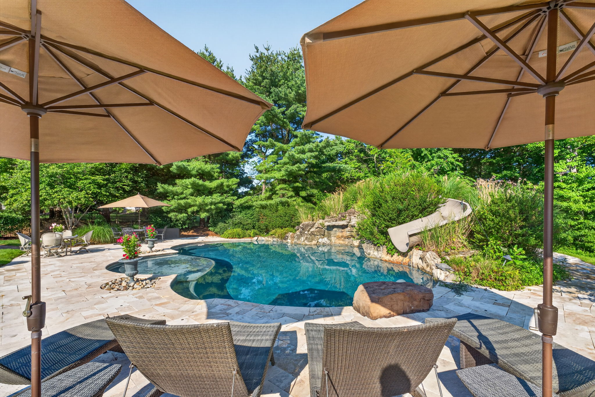 SALTWATER POOL Custom Heated Saltwater Pool with Travertine Coping And Patio Surround/Natural Stone Waterfall/Custom Slide/Pennsylvania Moss Rock Diving Stone. Polaris Aqua Plus Robotic Pool Cleaner (included).