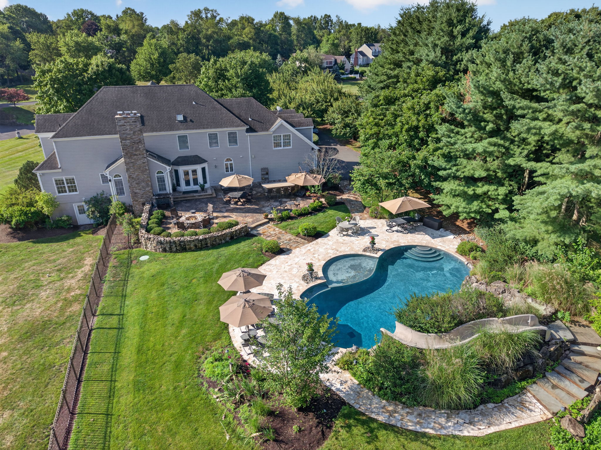 SALTWATER POOL Custom Heated Saltwater Pool with Travertine Coping And Patio Surround/Natural Stone Waterfall/Custom Slide/Pennsylvania Moss Rock Diving Stone. Polaris Aqua Plus Robotic Pool Cleaner (included).