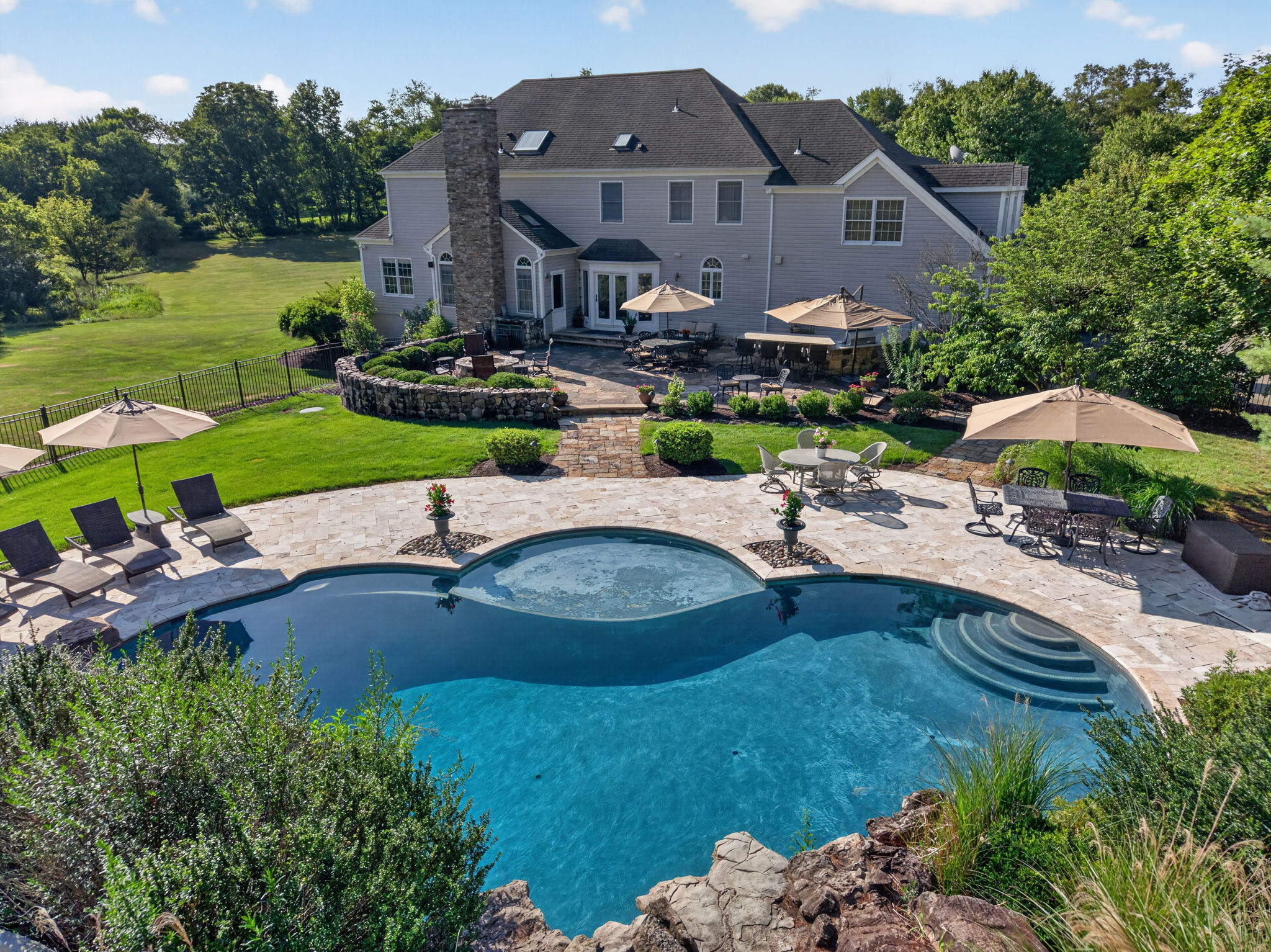 PATIO/POOL Completing the private backyard oasis is a heated saltwater pool with a custom pool slide, offering the ultimate resort-style experience right at home.