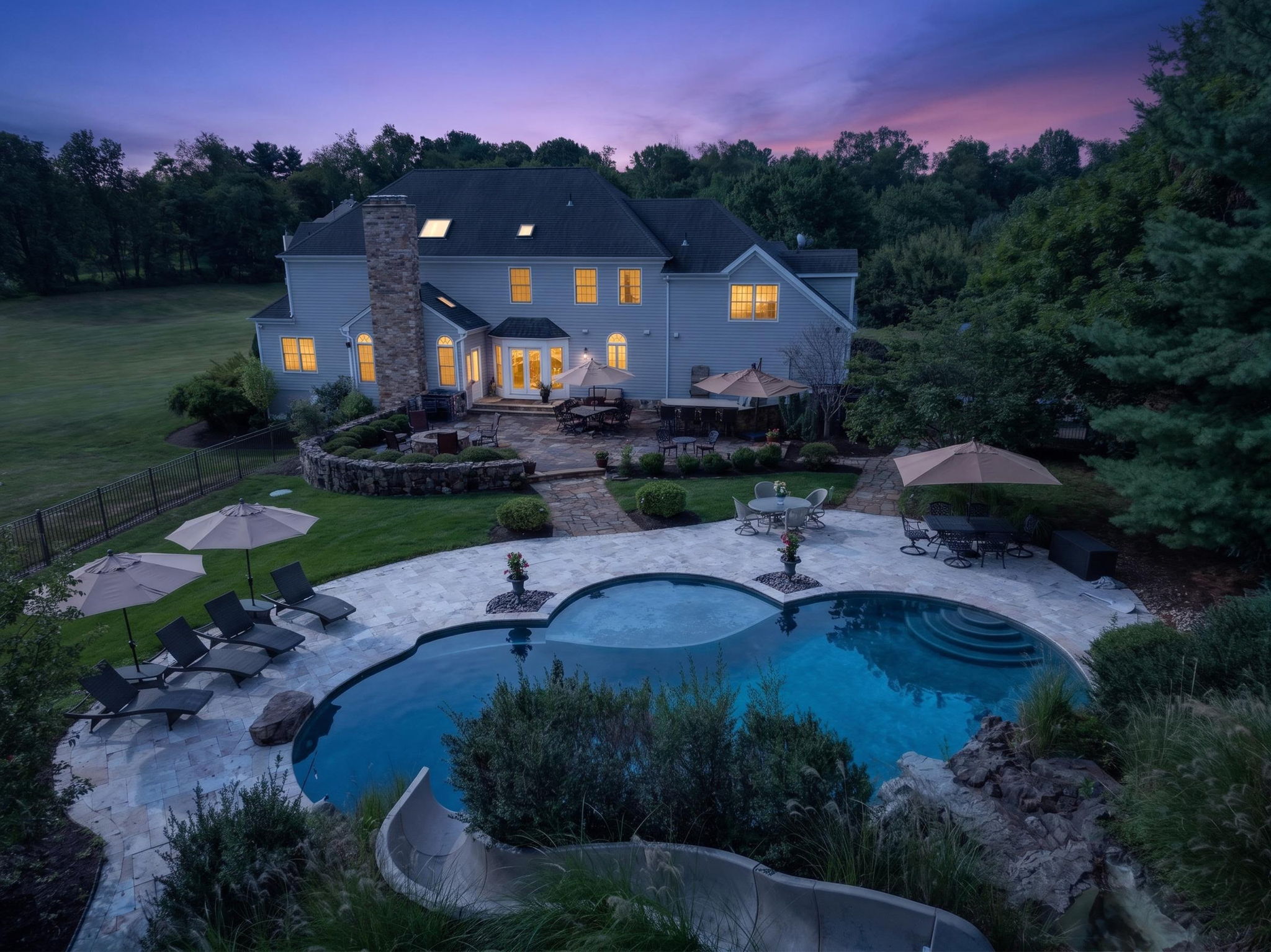 The private backyard oasis features a heated saltwater pool with a custom pool slide, offering the ultimate resort-style experience right at home.