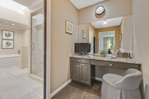 PRIMARY BEDROOM Make-up Vanity with Granite Countertop. In-wall Locking Jewelry Case with Mirror. Walk-in Closet with Organizer System