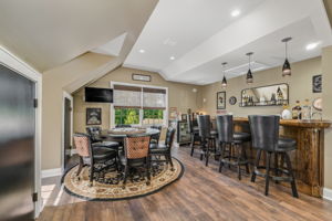 GAMEROOM The expansive game room is the ultimate entertainment destination, complete with a built-in bar, wet sink, and pool table-ideal for game nights, celebrations, or enjoying a casual evening at home.