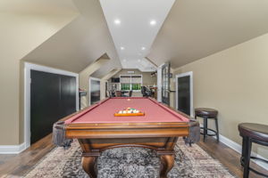 GAMEROOM The expansive game room is the ultimate entertainment destination, complete with a built-in bar, wet sink, and pool table-ideal for game nights, celebrations, or enjoying a casual evening at home.