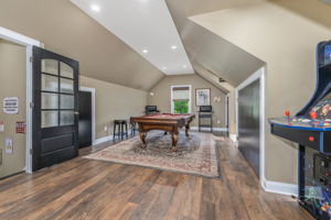 GAMEROOM The expansive game room is the ultimate entertainment destination, complete with a built-in bar, wet sink, and pool table-ideal for game nights, celebrations, or enjoying a casual evening at home.
