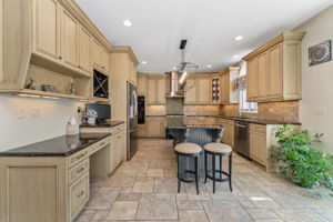 GOURMET KITCHEN Gourmet chef's kitchen features premium finishes, high-end appliances, and abundant prep space. Center Island with Breakfast Seating and Granite Countertop