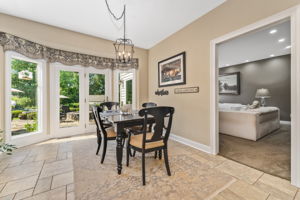 BREAKFAST AREA 4 Glass Panels/Patio Door Opens to Outdoor Kitchen and Stone Patio