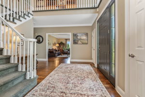 TWO STORY FOYER Andersen Entry Door with Sidelights, Crown Moulding, 2 Tier Candle Chandelier, Sentry Closets, Hardwood Flooring
