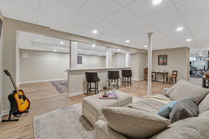 FINISHED LOWER LEVEL The finished walk-out lower level offers exceptional versatility with a spacious recreation room, dedicated fitness room, and generous storage areas to keep everything organized.