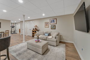 FINISHED LOWER LEVEL The finished walk-out lower level offers exceptional versatility with a spacious recreation room, dedicated fitness room, and generous storage areas to keep everything organized.