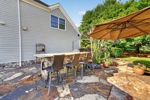 OUTDOOR KITCHEN The custom outdoor kitchen provides an extraordinary space for al fresco dining and gatherings. Professional 5 Series Grill with Rotisserie and TruSear Infrared Burner, Grill Storage, Granite Countertop, Refrigerator, Trash Receptacle