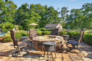 PATIO/STONE FIREPIT A sprawling stone patio with stone firepit creates the perfect setting for relaxing,