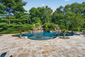 SALTWATER POOL Custom Heated Saltwater Pool with Travertine Coping And Patio Surround/Natural Stone Waterfall/Custom Slide/Pennsylvania Moss Rock Diving Stone. Polaris Aqua Plus Robotic Pool Cleaner (included).