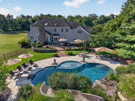The private backyard oasis features a heated saltwater pool with a custom pool slide, offering the ultimate resort-style experience right at home.