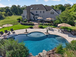 PATIO/POOL Completing the private backyard oasis is a heated saltwater pool with a custom pool slide, offering the ultimate resort-style experience right at home.