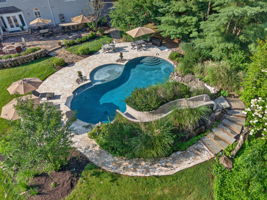 PATIO/POOL Completing the private backyard oasis is a heated saltwater pool with a custom pool slide, offering the ultimate resort-style experience right at home.