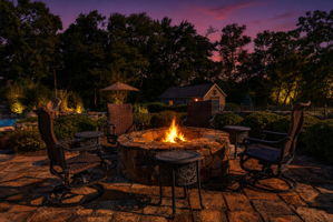 PATIO/STONE FIREPIT A sprawling stone patio with stone firepit creates the perfect setting for relaxing