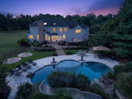 The private backyard oasis features a heated saltwater pool with a custom pool slide, offering the ultimate resort-style experience right at home.