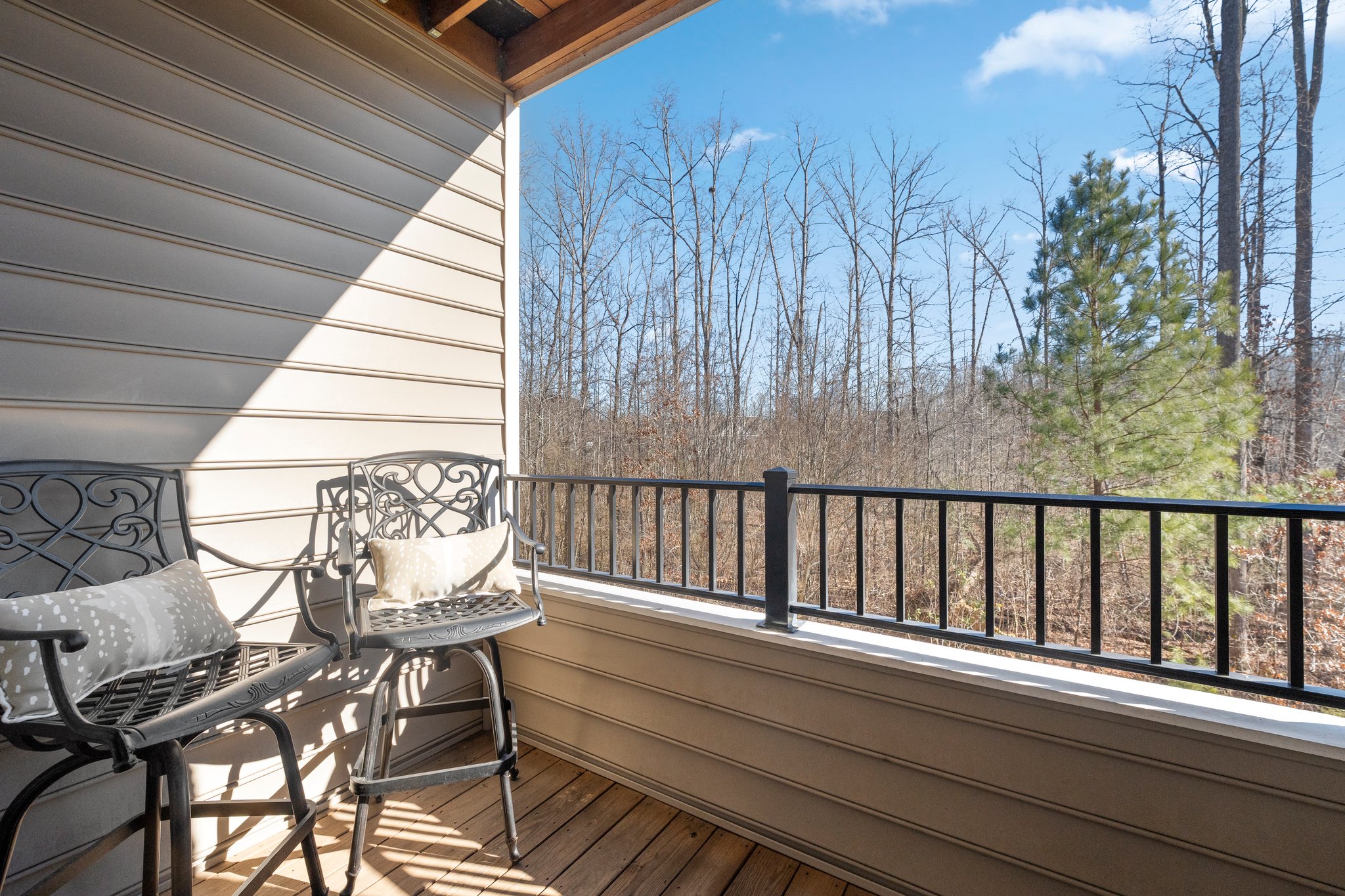 Private balcony overlooking natural wooded space