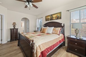 Arched doorway into closet area and bath