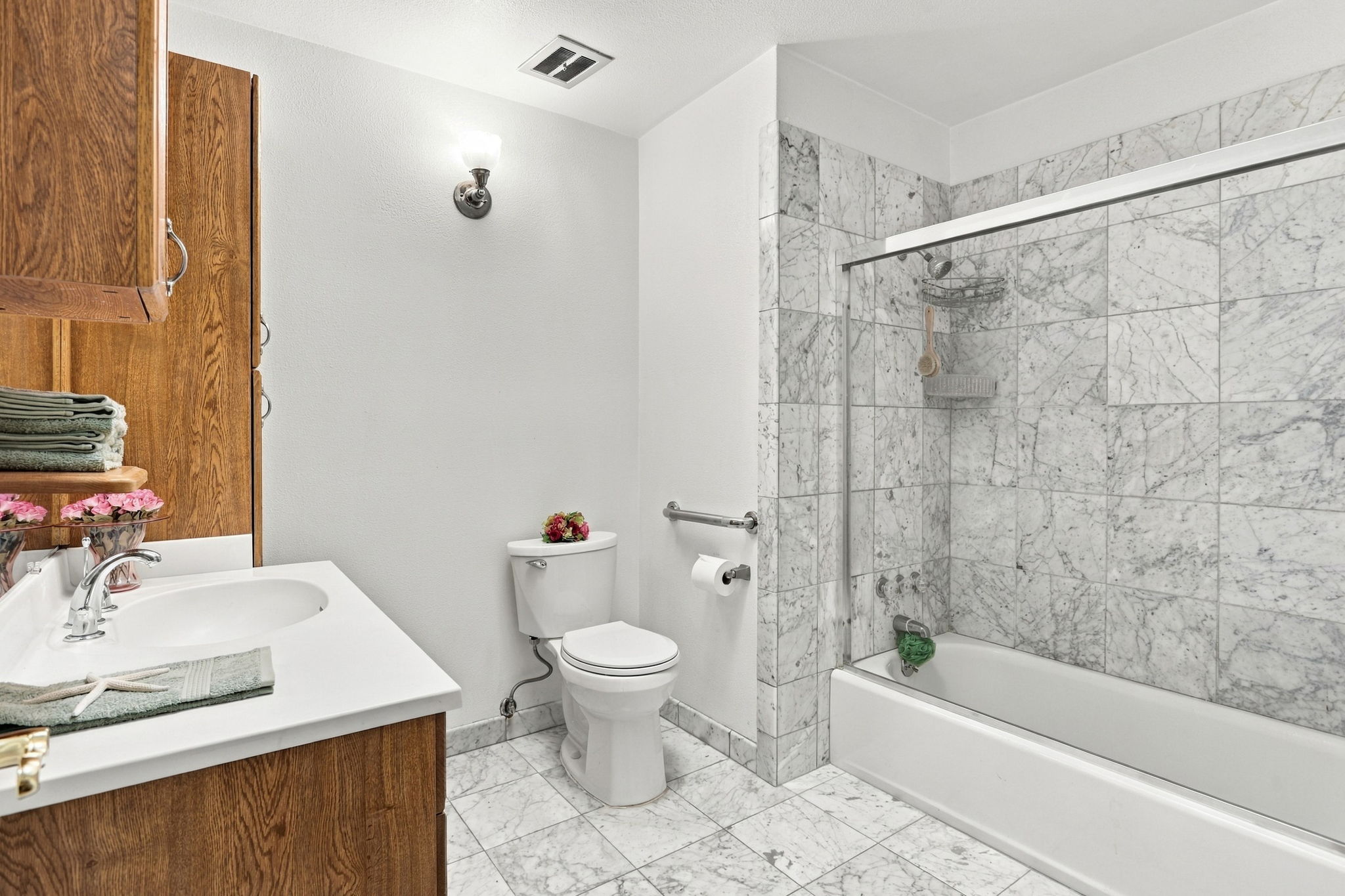 Hall Bath w/Gorgeous Natural Carrera Marble Floor w/Chrome Light Sconce & Grab Bar