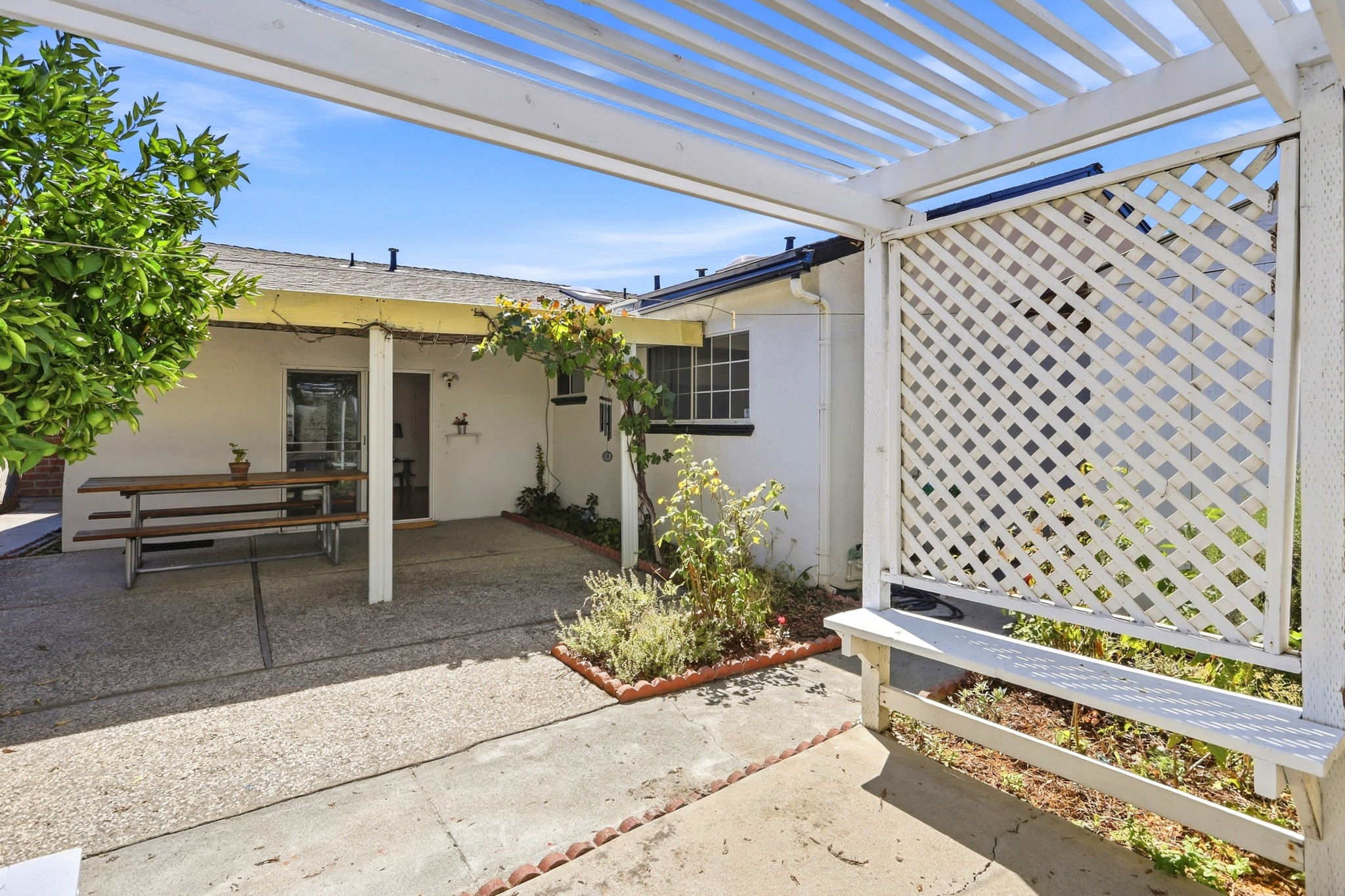 Backyard View of Covered Patio from LT side of Pergola with Path to the Shed's Back Door Access