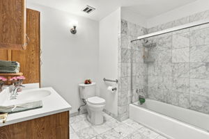 Hall Bath w/Gorgeous Natural Carrera Marble Floor w/Chrome Light Sconce & Grab Bar