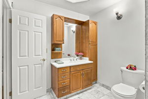 Hall Bath Skylight sheds natural light o/Vanity w/integral Linen Closet