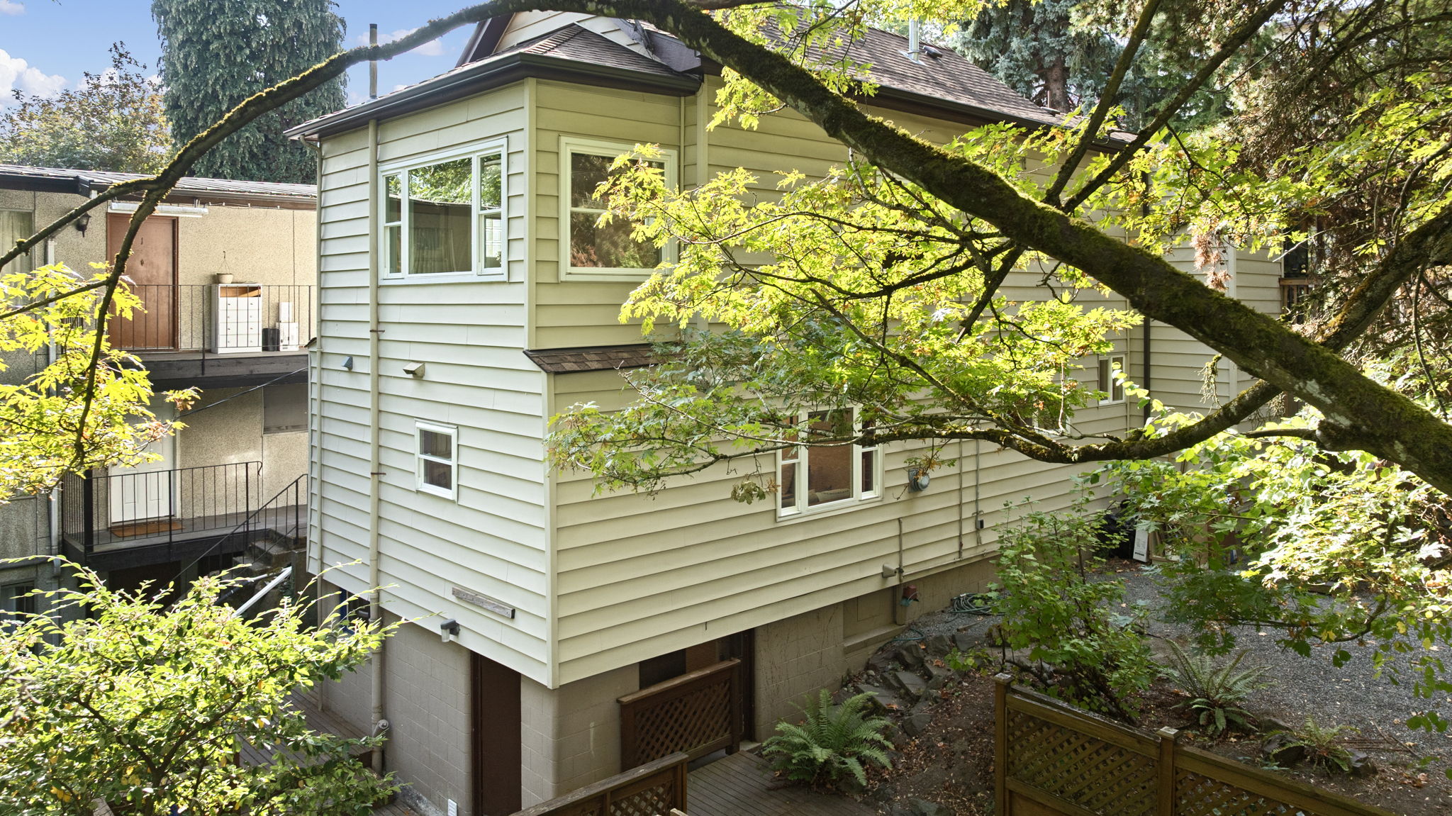 Tucked into the hillside, this home lives large with three full levels—while appearing as a modest one-story from the street. A private, tree-lined setting makes it feel like a hidden retreat.