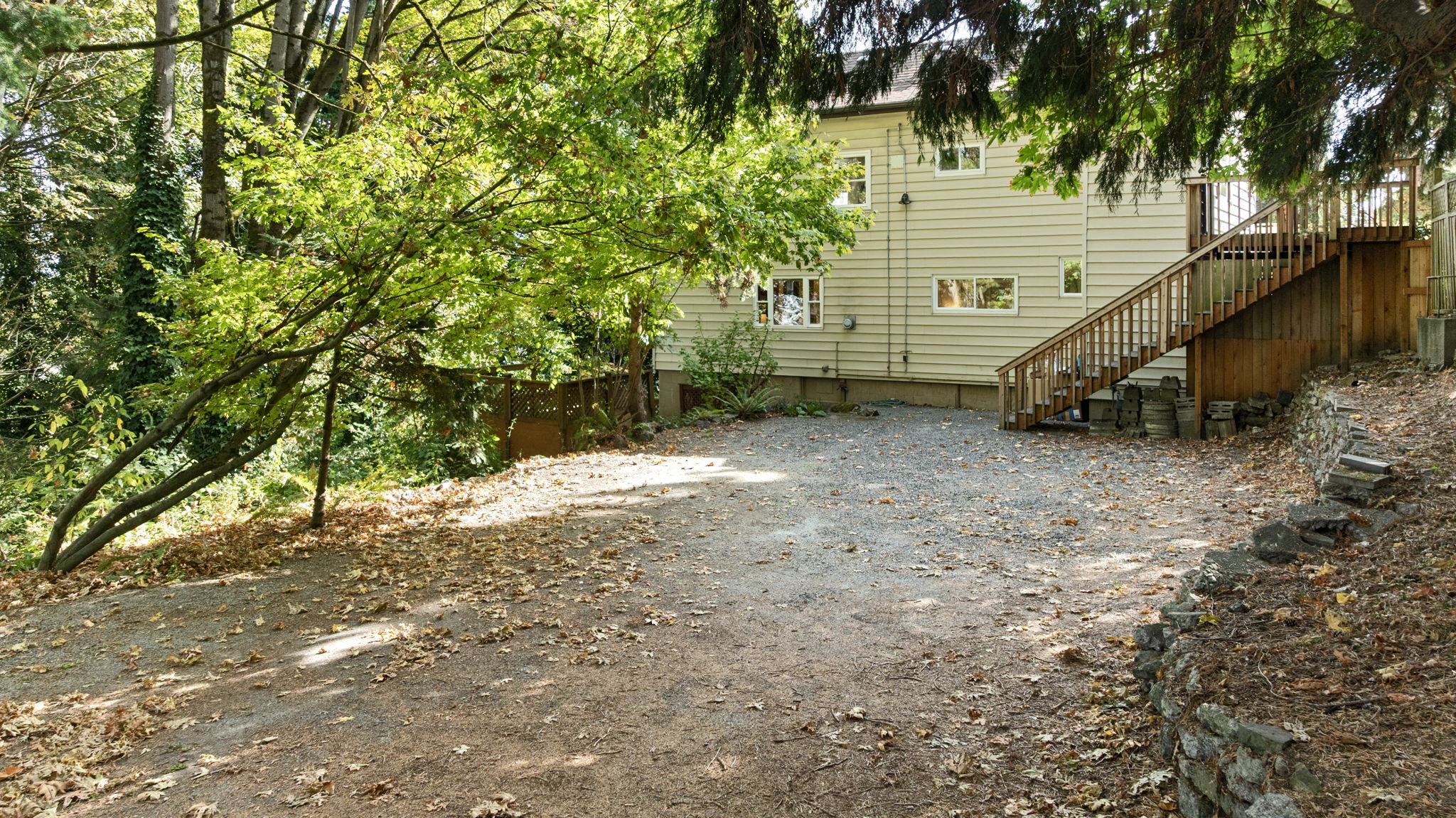 With limited street parking due to protected bike lanes, this separately deeded lot offers rare off-street convenience. Generously sized and tucked behind mature trees, it provides easy access, long-term flexibility, and everyday peace of mind—especially for multi-household living.